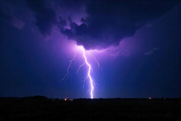 Dramatic shot of a powerful lightning bolt striking the ground during a thunderstorm at night, illuminating the dark landscape with intense light and energy , high voltage, nature, clouds