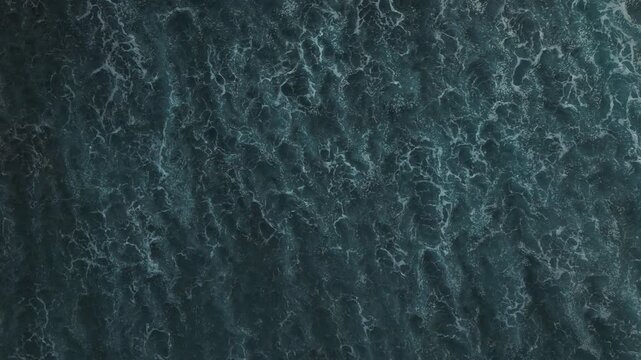 Aerial view of small coastal waves over black sand beach. Nusa Bali, Indonesia wipe