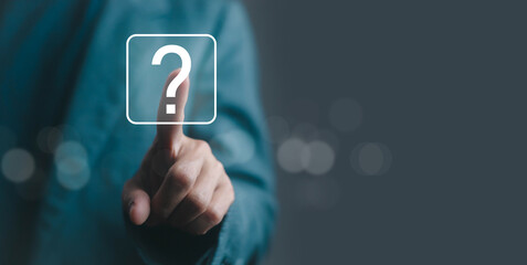 Businessman hand pointing on virtual question mark icon, concept of help, support, FAQ, solution, and online assistance. Perfect for technology, customer service, and digital business design.