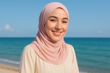 Smiling Malay woman in hijab enjoying beach holiday