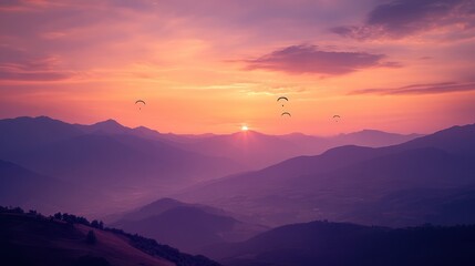 Enthralling sunset scene over misty mountain ridges with silhouettes of paragliders