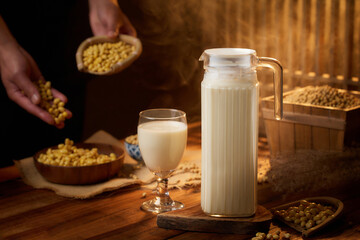 The Artisanal Process of Creating Tofu and Soy Milk by Hand,Grinding Soaked Soybeans with Stone Mill for Fresh Soy Milk