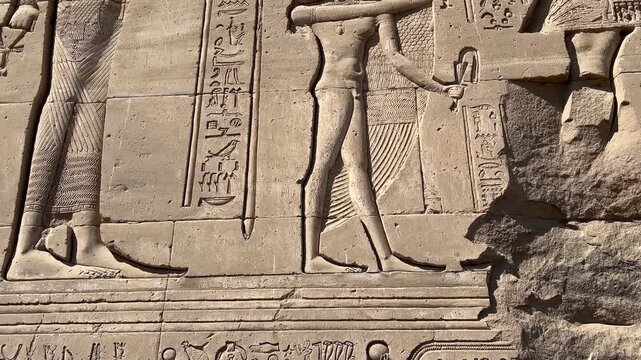 Carved relief of pharaoh with deities at Dendera Temple, Egypt