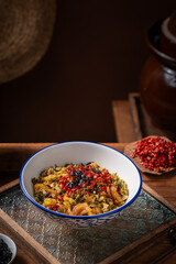 Sliced ​​pork with pickled mustard greens and chili peppers, old kitchen interior wooden table background