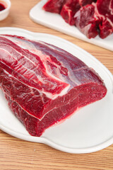 Fresh Raw Beef Cuts Display on White Plates Ready for Cooking