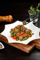 Diced Australian Beef Cubes with Fresh Herbs and Cherry Tomatoes on Rustic Wooden Board