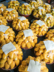 Fresh Tainong Mangoes Neatly Arranged in Bags at Fruit Market Stall