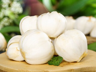 Fresh White Mushrooms on Bamboo Cutting Board with Herbs