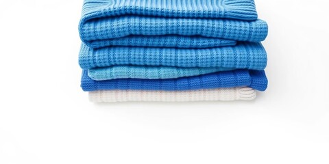 Fototapeta premium Neatly stacked folded blue sweaters, soft texture, clean white background, isolated, simple
