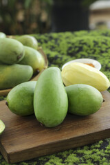 Fresh Hainan Green Mangoes Raw and Sliced on Wooden Board Tropical Fruit