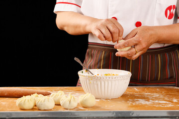 Chef Making Fresh Dough Buns - Filling and Shaping Wheat Flour for Baking on Wooden Board
