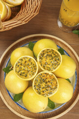 Fresh Golden Passion Fruit from Hainan China in Wooden Bowl with Tropical Juice Drink