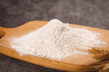 Fresh White Flour Pile on Wooden Board - Baking Ingredient for Bread and Pastries