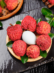 Fresh Lychee Fruits from Gaozhou China in Wooden Bowl - Exotic Tropical Seasonal Produce