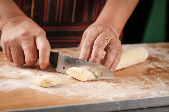 Chef Cutting Fresh Wheat Dough on Floured Cutting Board - Homemade Bread Making Process
