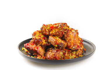 Fresh fried pork ribs with garlic on black dishes