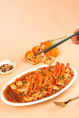 Garlic shrimp with vermicelli noodles on plate, chopsticks picking up prawns, spicy Asian seafood dish with chili and herbs
