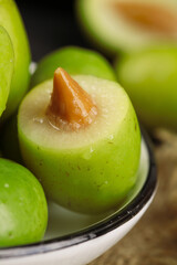 Fresh Green Olives with Pits in Bowl - Mediterranean Food Ingredient Close-up