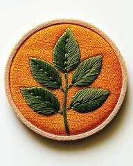Embroidered leaf design on vibrant fabric.
