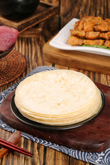 Fresh Flour Tortillas on Wooden Board with Asian Fusion Appetizers in Rustic Kitchen Setting