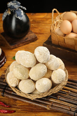 Traditional dumplings in basket with loose eggs and golden kitchen setting for cooking change