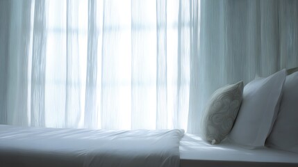 Hotel bed with crisp white linens and decorative pillow in soft morning light through sheer curtains.
