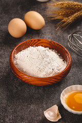 Fresh baking ingredients with flour, eggs and wheat for homemade bread making