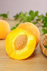 Fresh Golden Yellow Peach Halves with Pit on Wooden Board - Sweet Summer Fruit