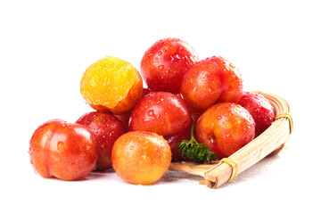 Fresh Colorful Plums with Water Droplets in Wicker Basket - Healthy Stone Fruit Collection