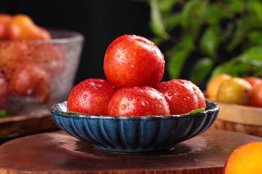 Fresh Red Plums in Bowl - Guangdong Organic Stone Fruit with Water Droplets on Wooden Table - Powered by Adobe