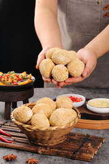 Chef Hands Holding Golden Breadcrumbs for Special Coating Recipe with Eggs and Kitchen Ingredients