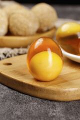 Golden Soft-Boiled Egg with Runny Yolk on Wooden Board - Breakfast Cooking Preparation