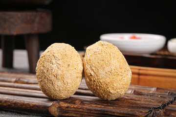 Fresh Whole Coconuts with Natural Husks on Wooden Rack in Kitchen Setting