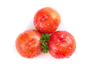 Fresh Red Plums with Water Drops and Parsley on White Background