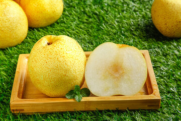 Fresh Dangshan Pears in Wooden Box on Green Grass Background - Crown White Pears Sliced and Whole