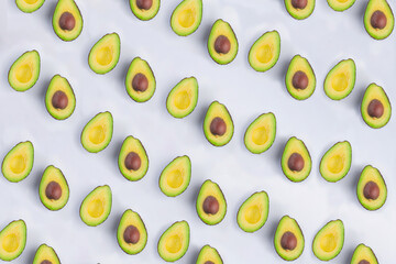 Whole and half avocado isolated on white background close-up.