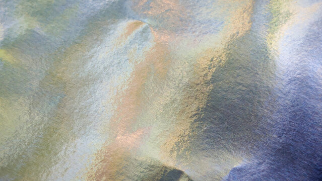 Iridescent silver foil paper texture, abstract festive background with pastel colors