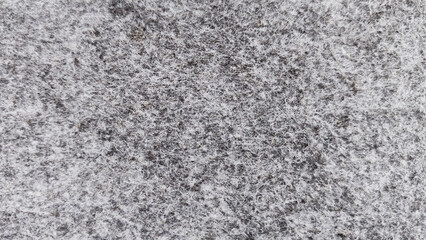Grey abstract fibrous background, texture of felt fabric.