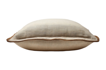 Soft beige decorative throw pillow with piped edges isolated.