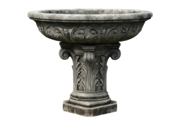 Antique carved stone garden birdbath on an ornate pedestal.