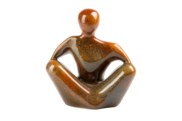 Stylized brown stone sculpture of a person in a meditation pose.