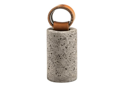Heavy cylindrical concrete doorstop with a brown leather loop handle.