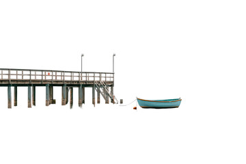 A solitary turquoise boat rests beside a long wooden pier.
