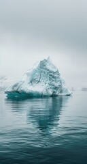 Antarctic iceberg, calm ocean, misty day, reflection; travel poster