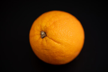 bright orange fruit on black background