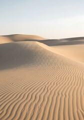 Gentle dune waves in sunlight at sunset, natural sand patterns