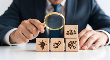 Professional analyzing business strategy with wooden blocks showing idea, process, target, and growth concepts