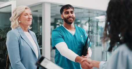 Handshake, doctor and people in hospital, welcome or onboarding with introduction, smile or hello. Greeting, healthcare or employees with cooperation, shaking hands or partnership with clinic success