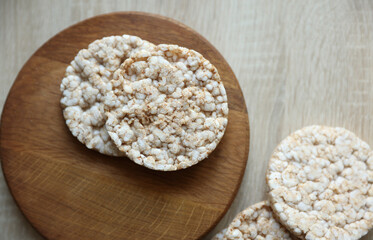 Rice round crackers, diet bread on wooden plate