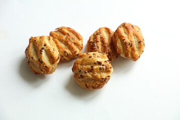 Mini pies with sesame seeds on white background © splitov27